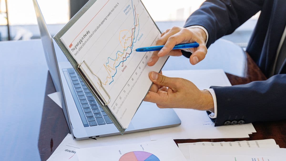 A specialist reviews financial documents and a residency certificate at a desk
