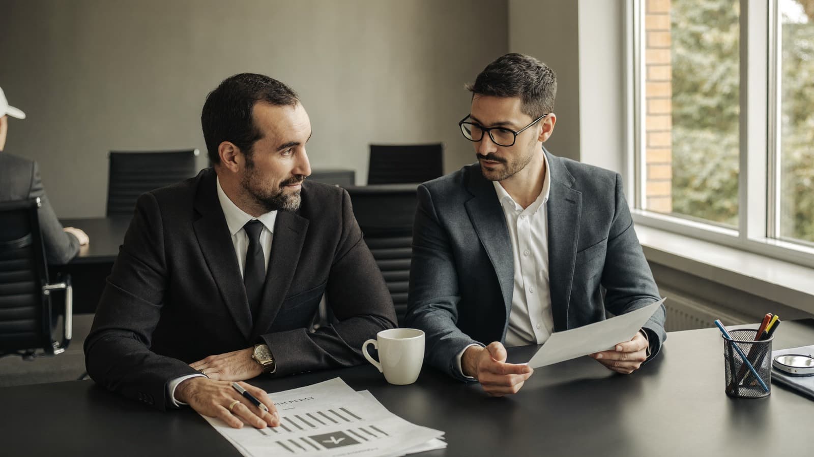 A founder and a consultant discussing documents