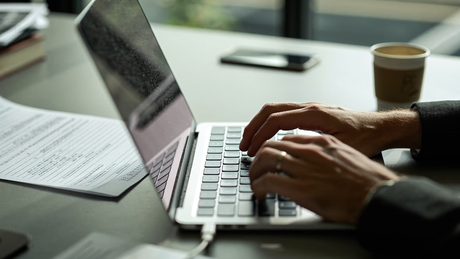 Paying a contractor on a laptop in an office